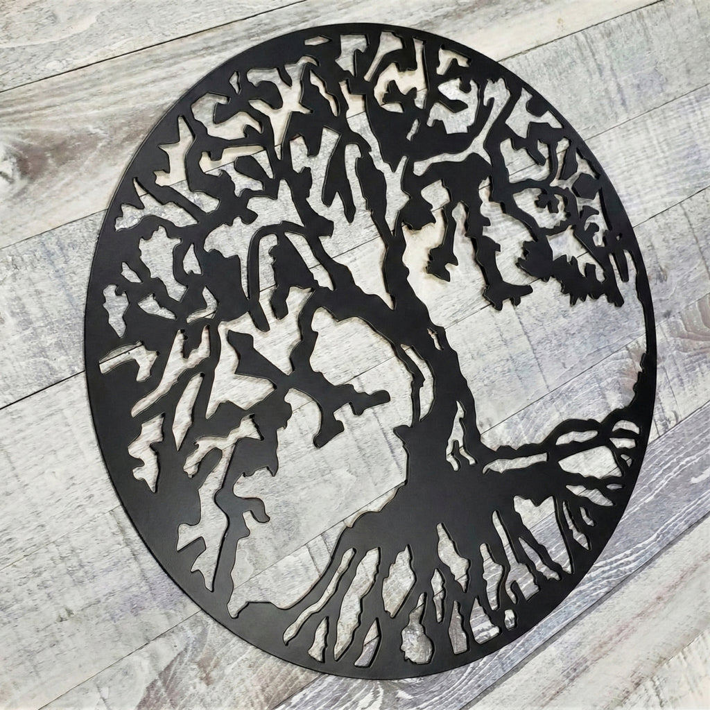 Decorative metal tree wall art on a wooden floor