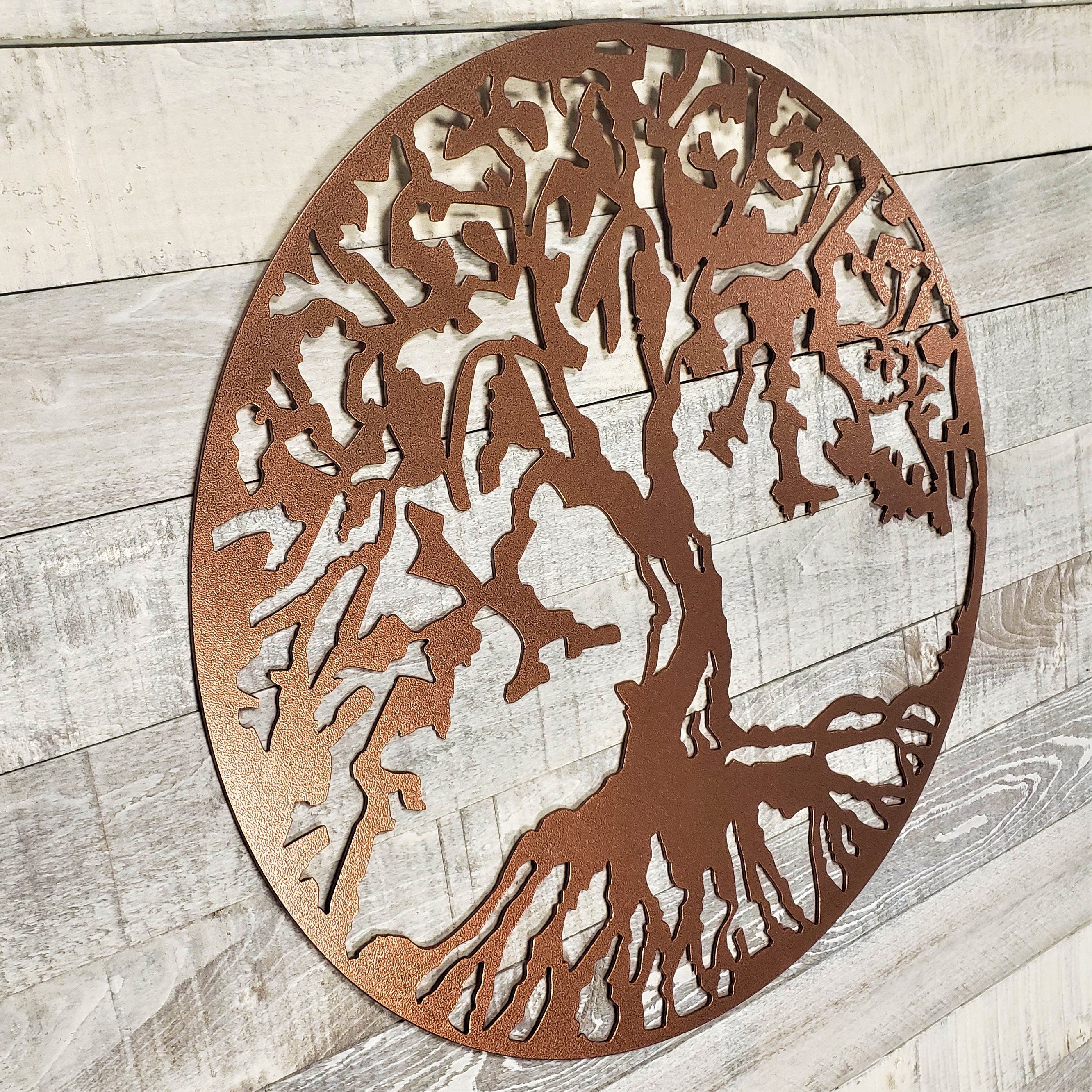 Decorative metal tree wall art on a wooden background