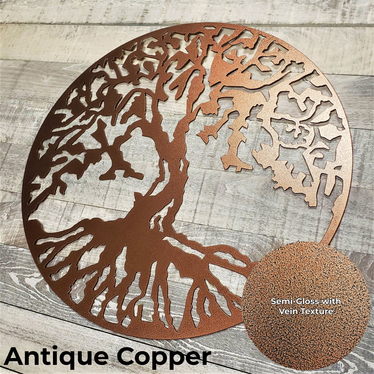 Decorative metal tree wall art in antique copper on a wooden surface