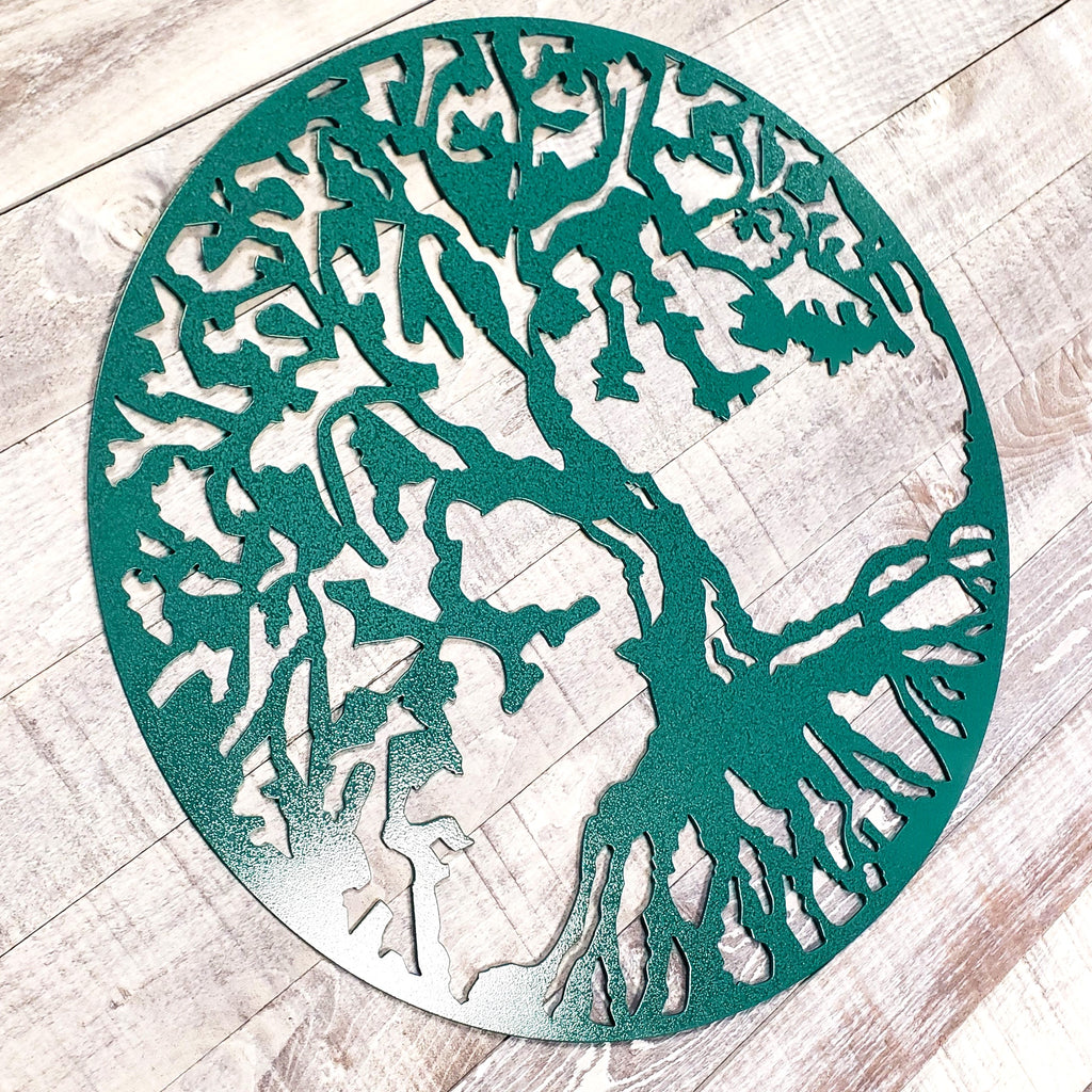 Decorative metal tree wall art on a wooden floor
