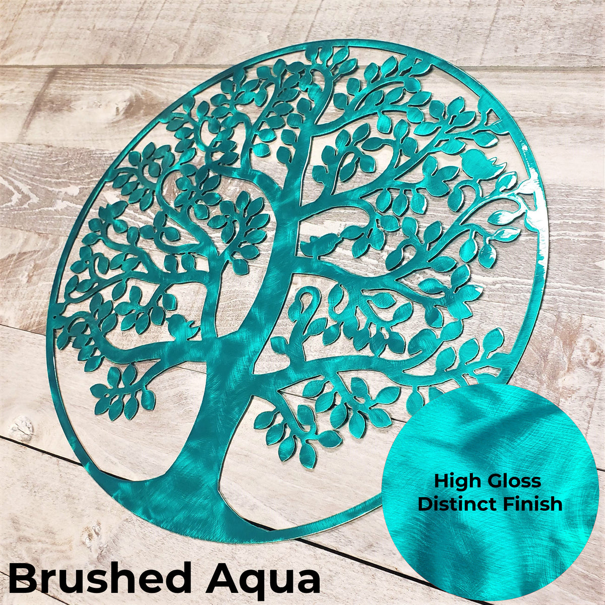 tree of life metal wall art with a brushed aqua finish on a wooden background