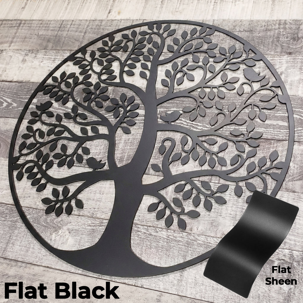 Decorative metal tree wall art in flat black on a wooden background