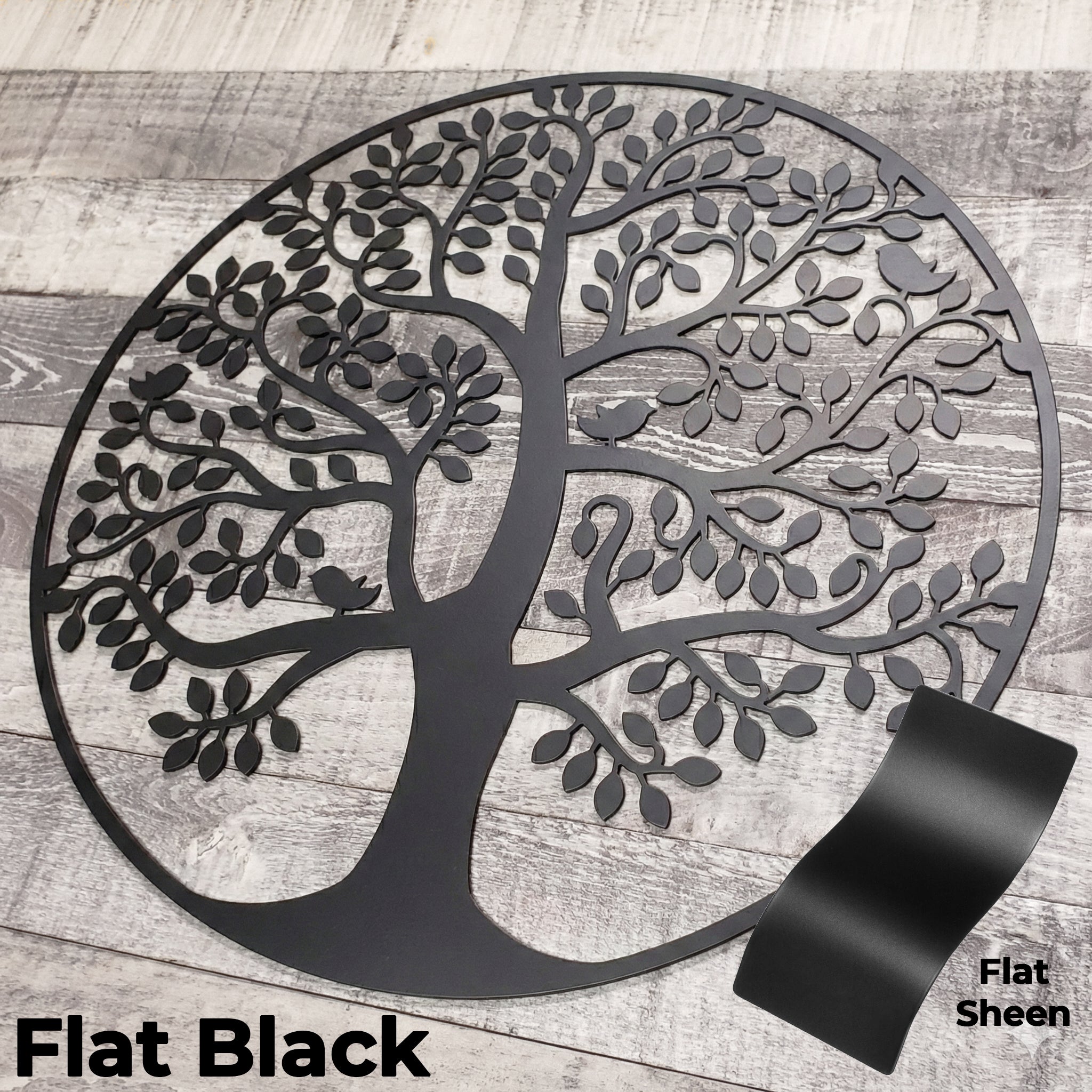 Decorative metal tree wall art in flat black on a wooden background