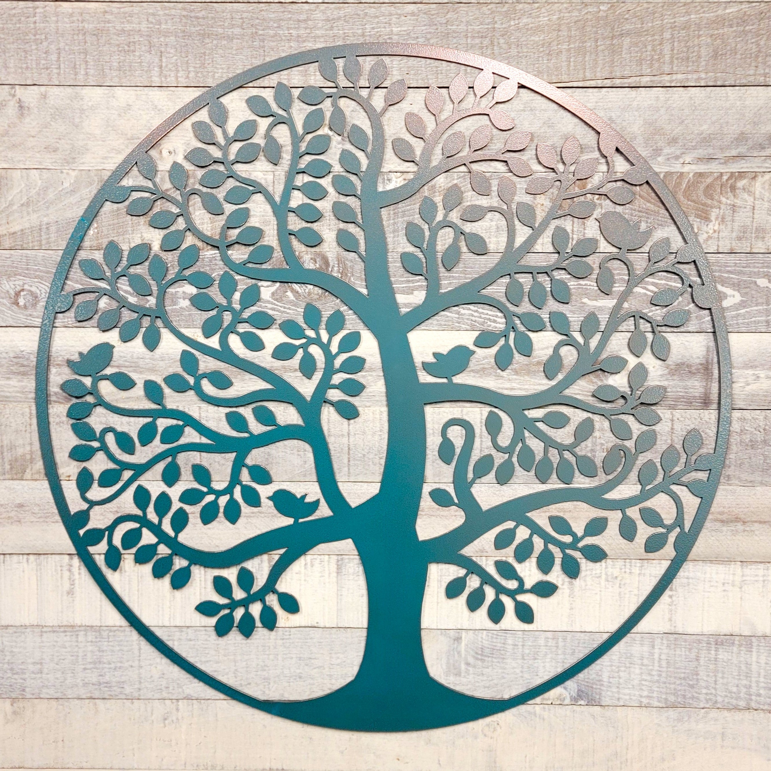 Decorative metal tree wall art on a wooden background