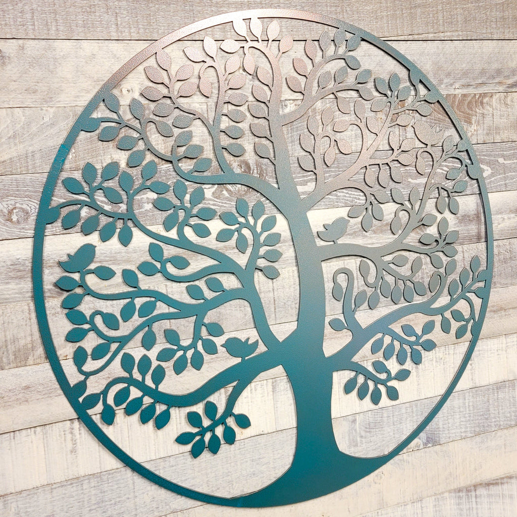 Decorative metal tree wall art on a wooden background