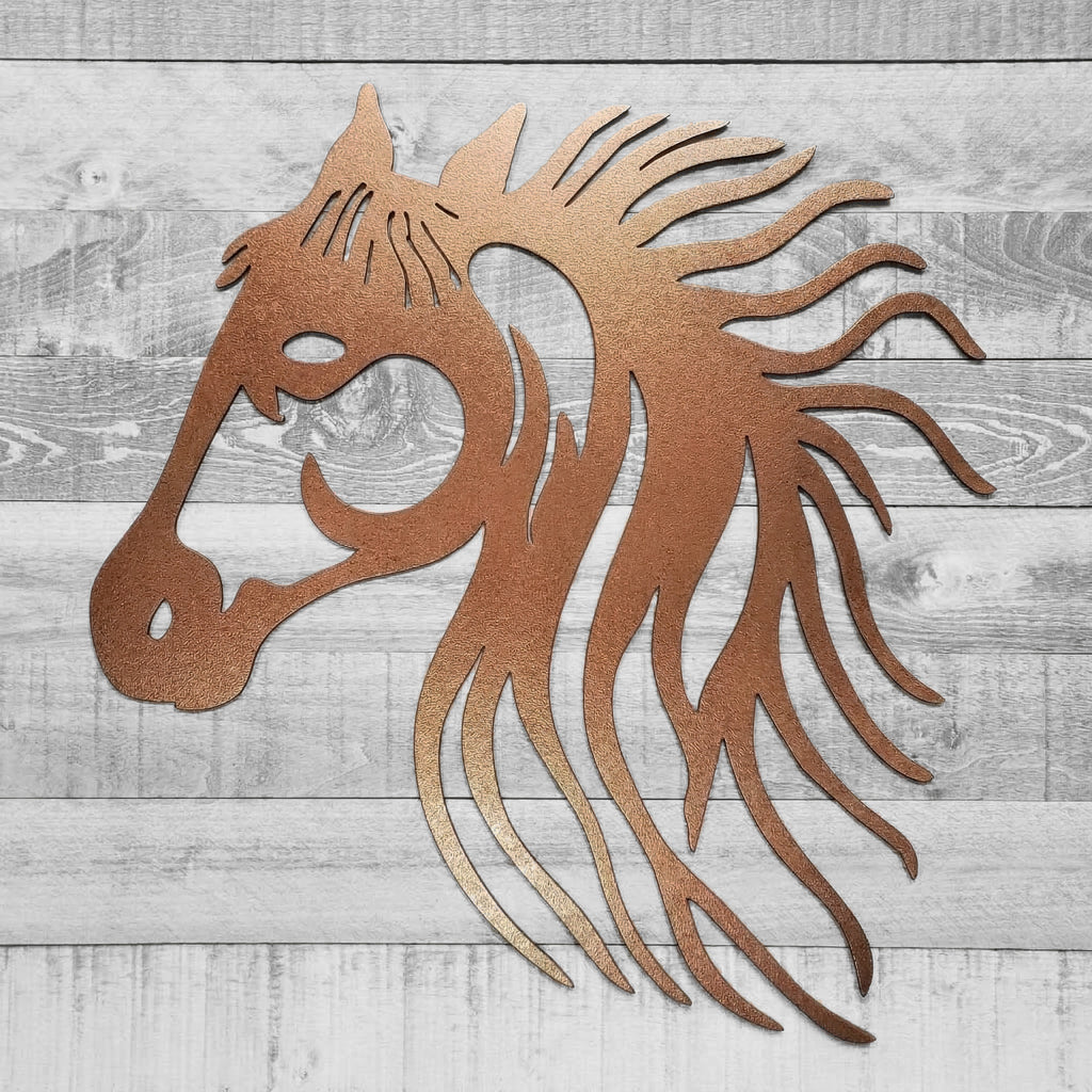 Copper-colored metal horse head wall art on a wooden background
