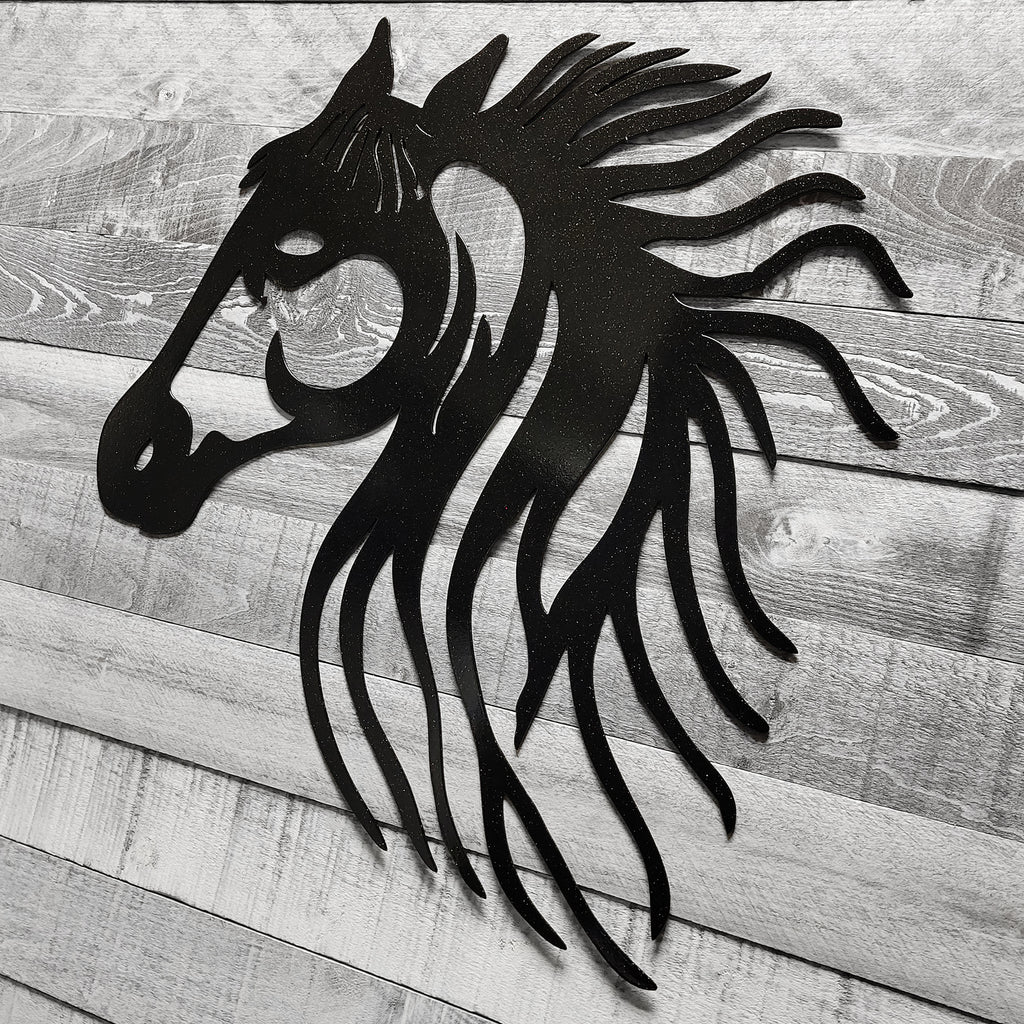 black metal horse head wall art on a wooden background
