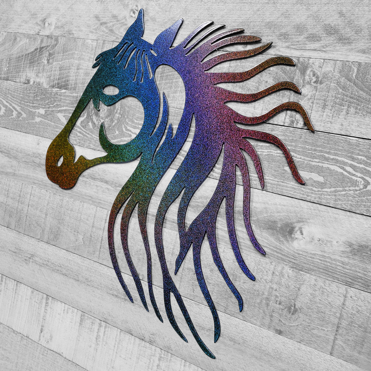 rainbow-shifting metallic metal horse head wall art on a wooden background