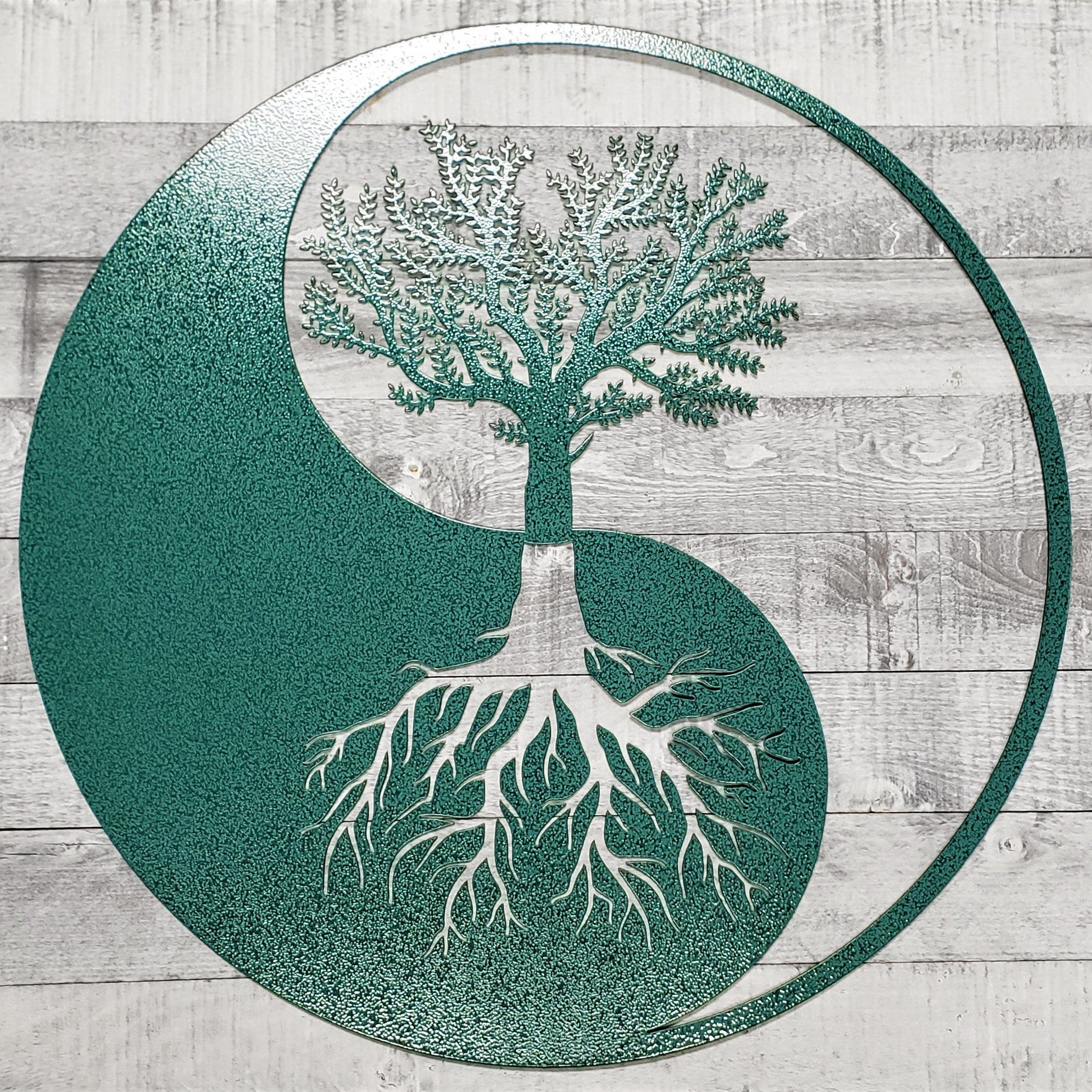 Yin yang symbol with a tree and roots on a wooden background