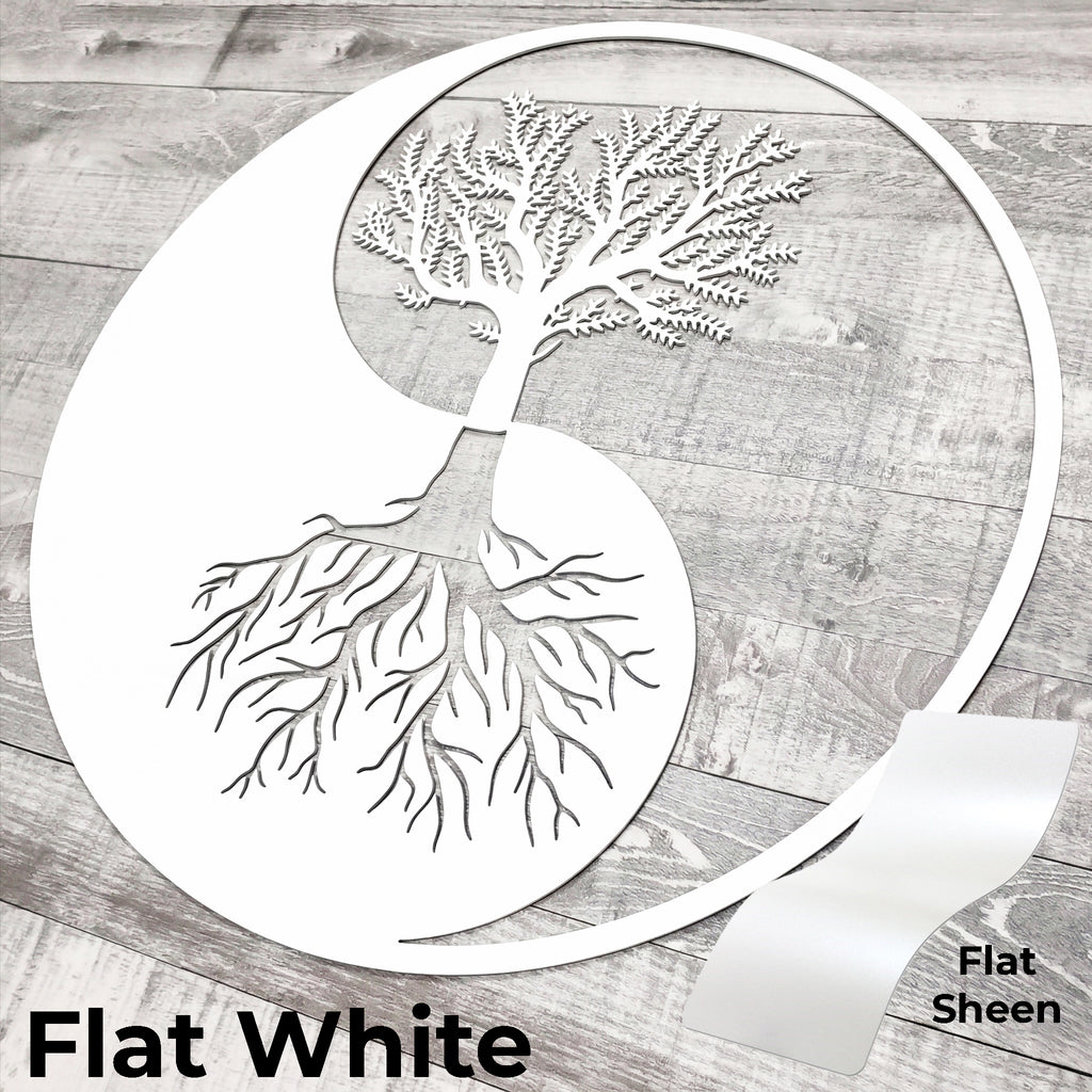 Decorative metal wall art with tree design on a wooden surface, labeled 'Flat White'.