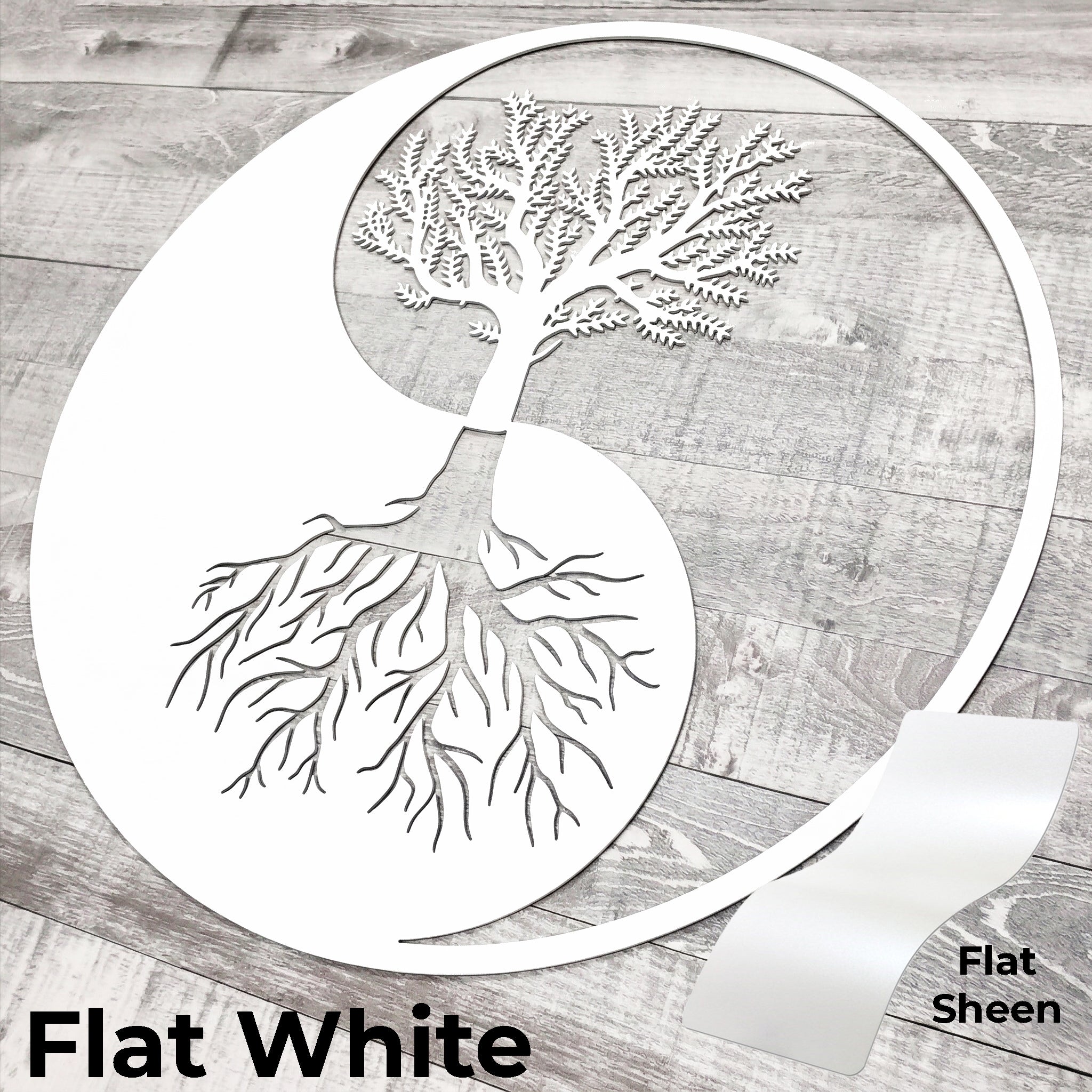 Decorative metal wall art with tree design on a wooden surface, labeled 'Flat White'.