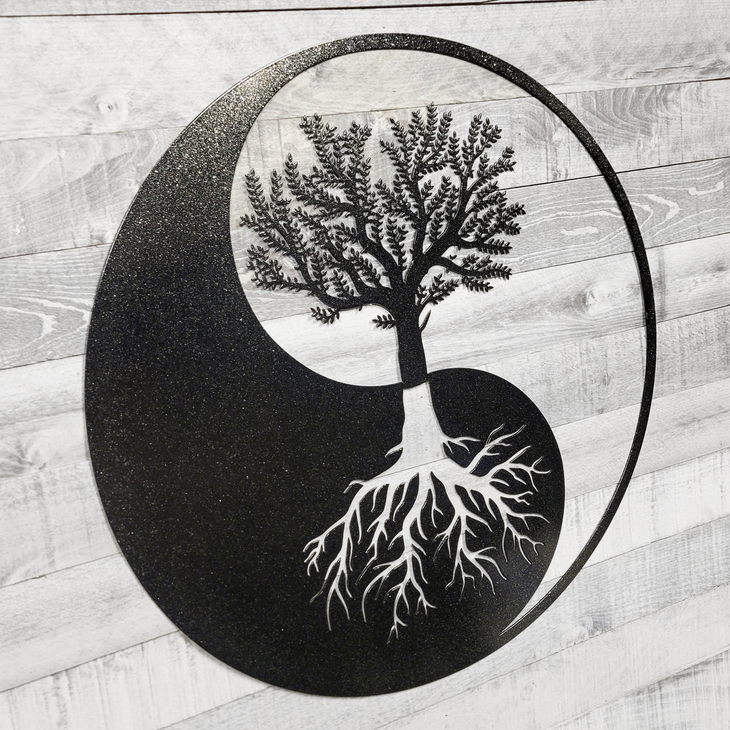 Yin yang symbol with a tree and roots on a wooden background