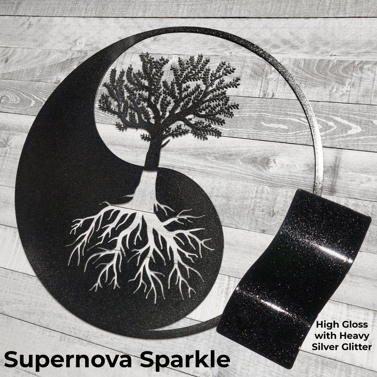 Decorative wall art with tree design and high gloss black finish on a wooden surface.